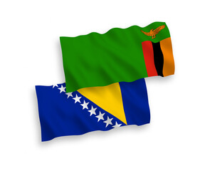 National vector fabric wave flags of Republic of Zambia and Bosnia and Herzegovina isolated on white background. 1 to 2 proportion.
