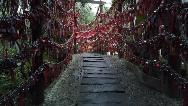 Red lucky gift bags hanging on trees in Jinli public park, Chengdu, Sichuan province, China