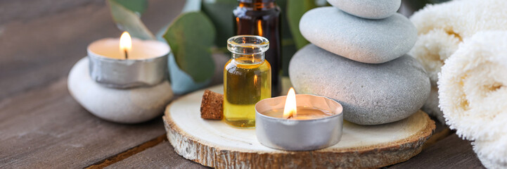 Assortment of natural oils in glass bottles on wooden background. Concept of pure organic ingredients in cosmetology. Bath accessories, atmosphere of harmony, relax. Banner. Healthy lifestyle