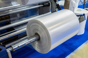 industrial machine with roll of newly produced transparent plastic film - 483524977
