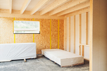 Interior corner of a room in a wooden house under construction - obrazy, fototapety, plakaty