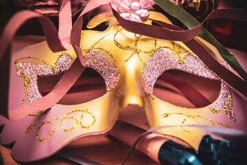 golden mask and noisemaker on background. Happy Holidays