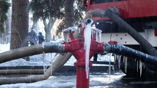 Fire hose with frozen water in winter. Extinguishing a fire in winter during frost