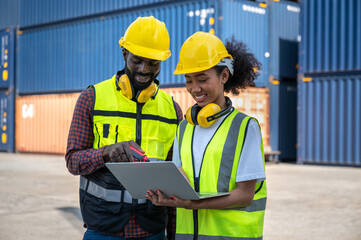 Engineering, foreman use laptop computer with containers background	