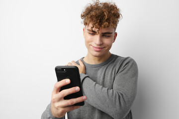 Fototapeta premium handsome guy looking at the phone fashion Lifestyle unaltered