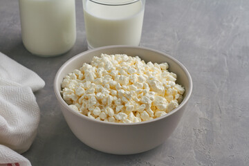 cottage cheese, curd in a grey bowl on grey background