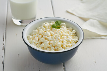 cottage cheese, curd in a brown bowl on wooden background