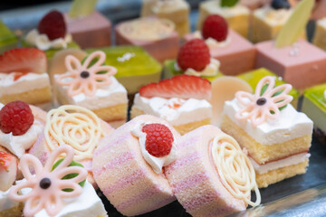 A lot of pink roll cakes and small cakes