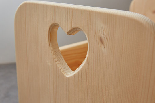 wooden piece with a carved heart. close up