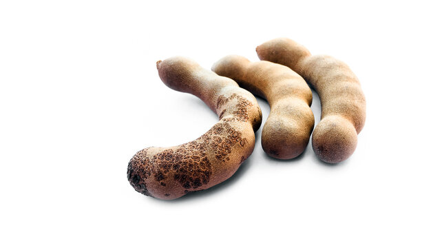 Asian ripe sweet tamarind fruit on white background.