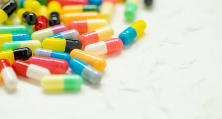 colorful capsule pills on white background with free space