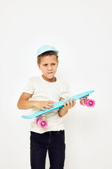 Little boy skateboard in hands posing lifestyle childhood