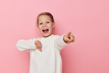 Portrait of happy smiling child girl white sweater posing fun isolated background