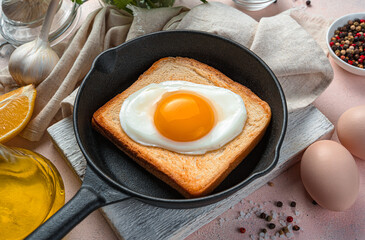 Breakfast with fried eggs on fried toast close-up. Side view, horizontal.