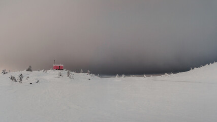 Cabin in evening winter. Dubldom on the mountain Volodyanaya Kandalaksha, Murmansk region in Russia. Panoramic view.
