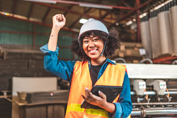 Engineer asian and african woman wearing safety helmet and vest holding clipboard and take note on...