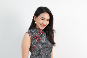 Beautiful young elegant southeast Asian woman wearing modern Chinese cheongsam dress pose smile look