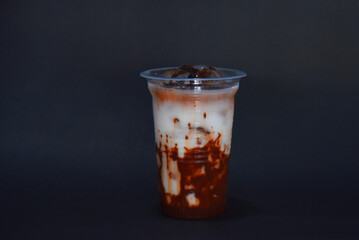 Chcolate drink mix with milk and Cincao topping, two layers look, isolated on color background