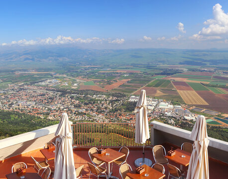 Cafe overlooking the Hula valley. Kiryat Shmona city and beautiful farming landscape with agricultural land. Upper Galilee. Northern Israel