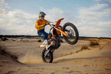 Fototapeta na wymiar Skilled moto rider making stunt on motorbike