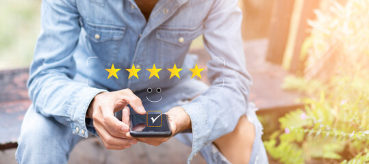 Customer pressing on smartphone with happy  and five stars icon for feedback review satisfaction service and copy space, Business review concept	