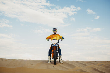 Motorcross rider with raised hand front view
