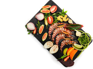 Fresh Tiger Shrimp decorated with spices and herbs on a wooden pad.Isolated on white background.