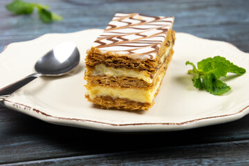 millefeuille in a white plate on a gray background