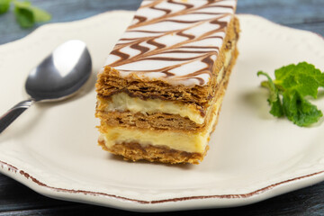 millefeuille in a white plate on a gray background