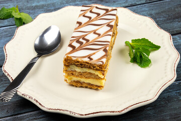 millefeuille in a white plate on a gray background