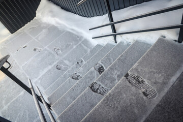 Fototapeta na wymiar Footprints in the snow on the stairs. Outdoors. Winter