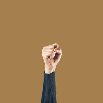 Hands for Protest or Strike isolated on Yellow background . Fist Gesture for Punch Raising Up