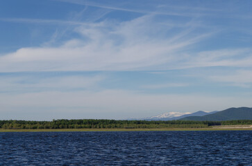 Beautiful view of the clouds and mountains from the bank of the Barguzin River.