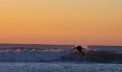 Riding the waves in Bali with surfing paradise and sunset sky scene background