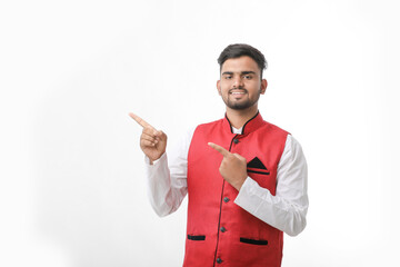 Young indian man in traditional wear and giving expression on white background.