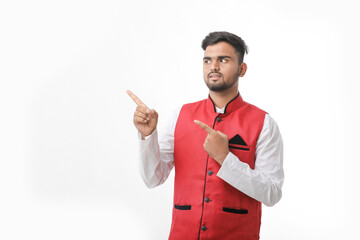 Young indian man in traditional wear and giving expression on white background.
