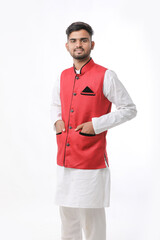 Young indian man in traditional wear and giving expression on white background.