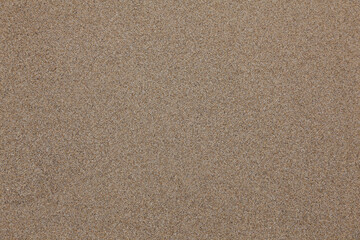 Fototapeta na wymiar Brown sand close up. The texture of beach sand.