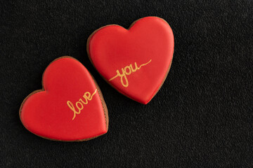Red homemade cookies shape of hearts. Valentine's Day, inscription love you