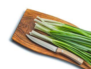 Green Onions Stack And Kitchen Knife On Wooden chopping Board Isolated
