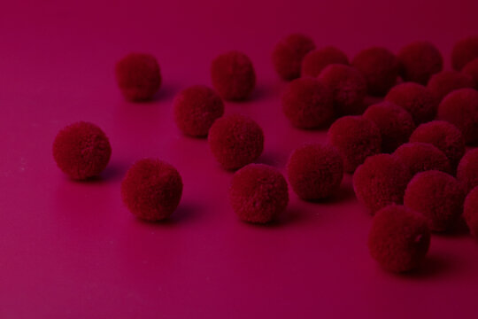 Red Pom Pom On Red Background