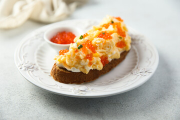 Scrambled eggs toast with cream cheese and caviar