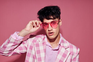 pretty man in pink glasses pink blazer posing studio isolated background unaltered