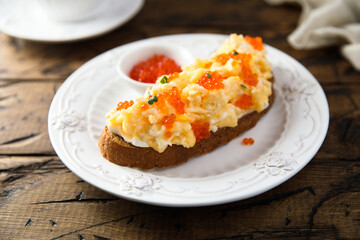 Scrambled eggs toast with cream cheese and caviar