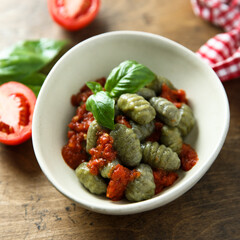 Homemade spinach gnocchi with tomato sauce