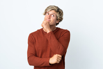 English man over isolated white background thinking an idea while looking up © luismolinero