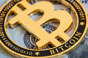Fototapeta na wymiar Bitcoin on 100 dollar bill background