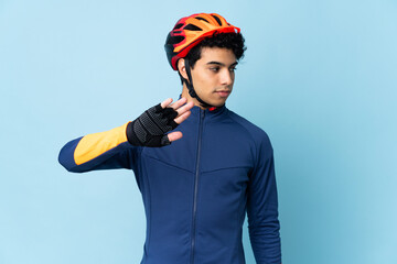 Venezuelan cyclist man isolated on blue background making stop gesture and disappointed - obrazy, fototapety, plakaty