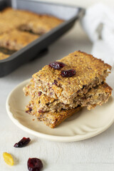 Several pieces of energy bars lie in a saucer. Selective focus. Healthy food concept. Vertical orientation.