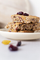 Several pieces of energy bars lie in a saucer. Selective focus. Healthy food concept. Vertical orientation. Selective focus.